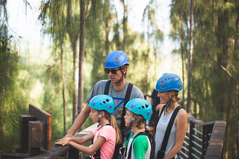 A family reading a sign at CLIMB Works Keana Farms.