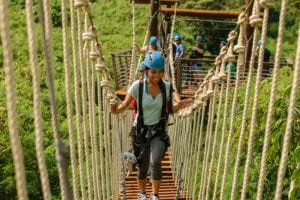 girl crossing sky bridge in hawaii